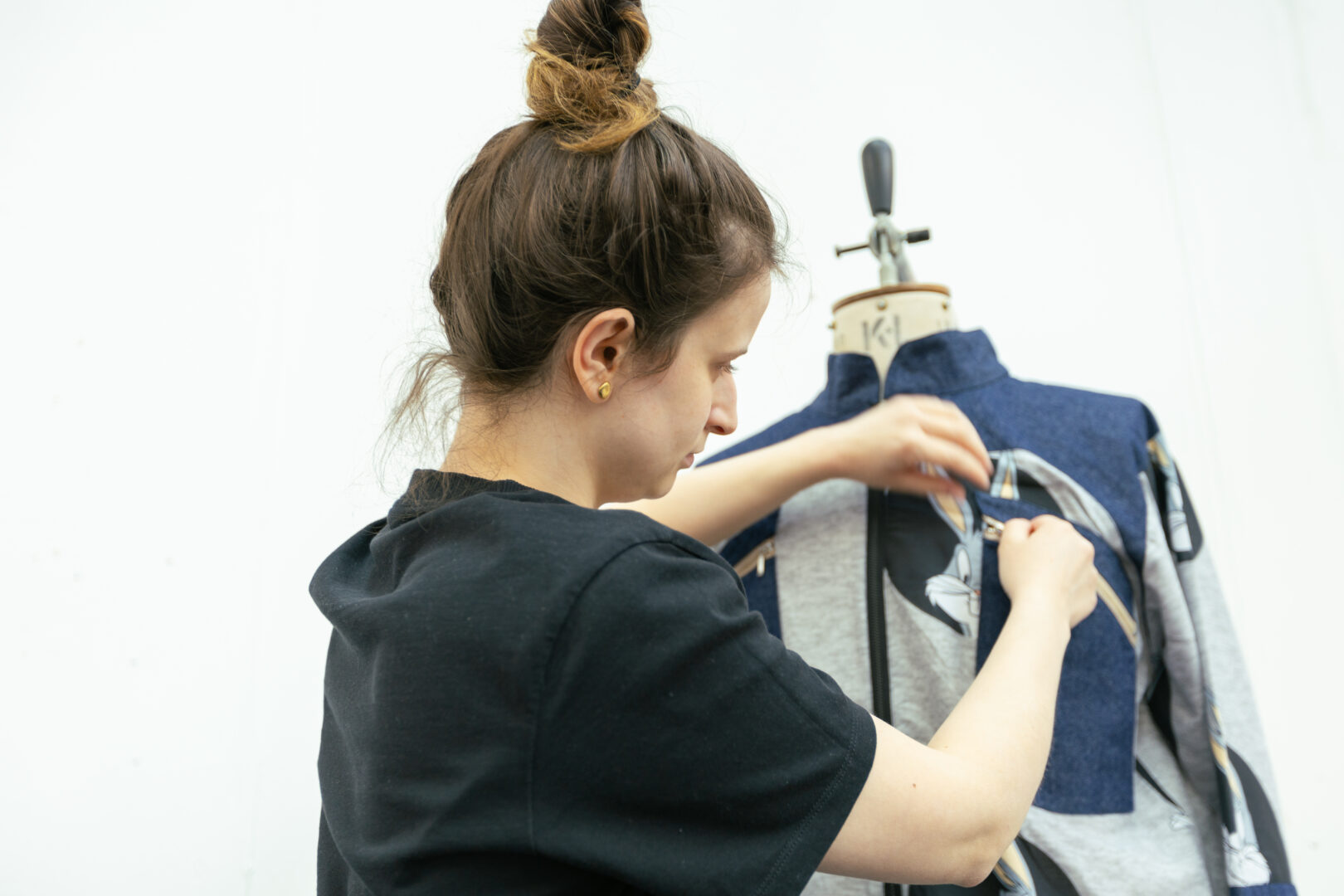 fashion student fitting sleeves onto a piece of clothing