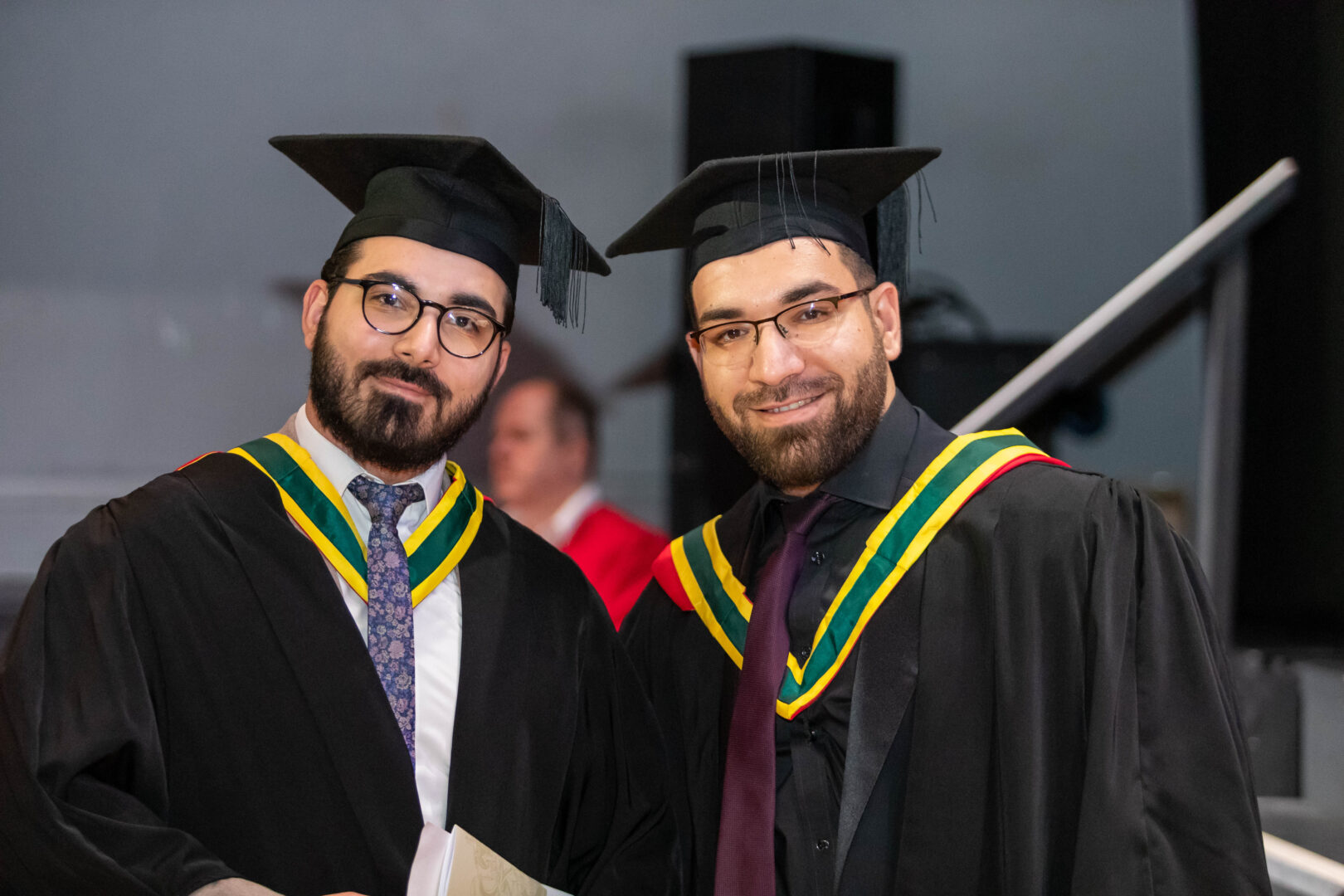 two graduates shaking hands