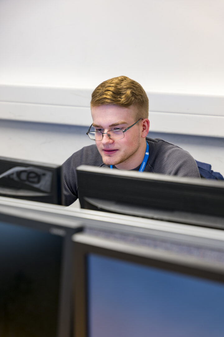 student sat at a computer