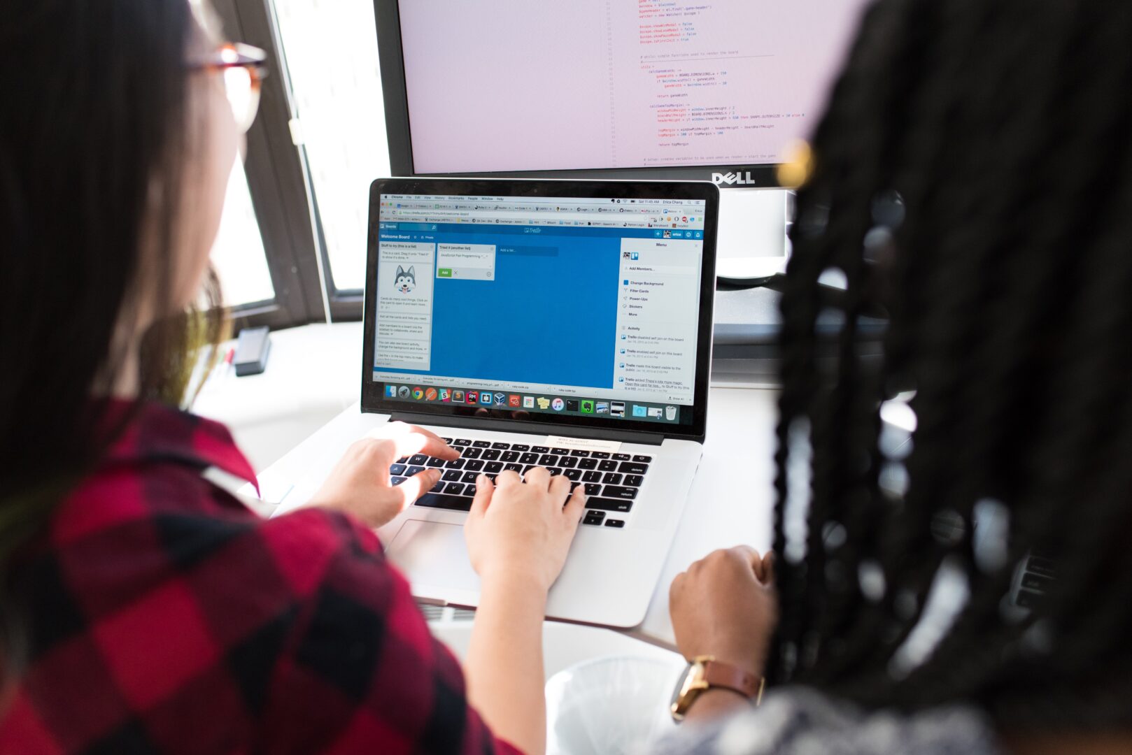 students sat at a laptop