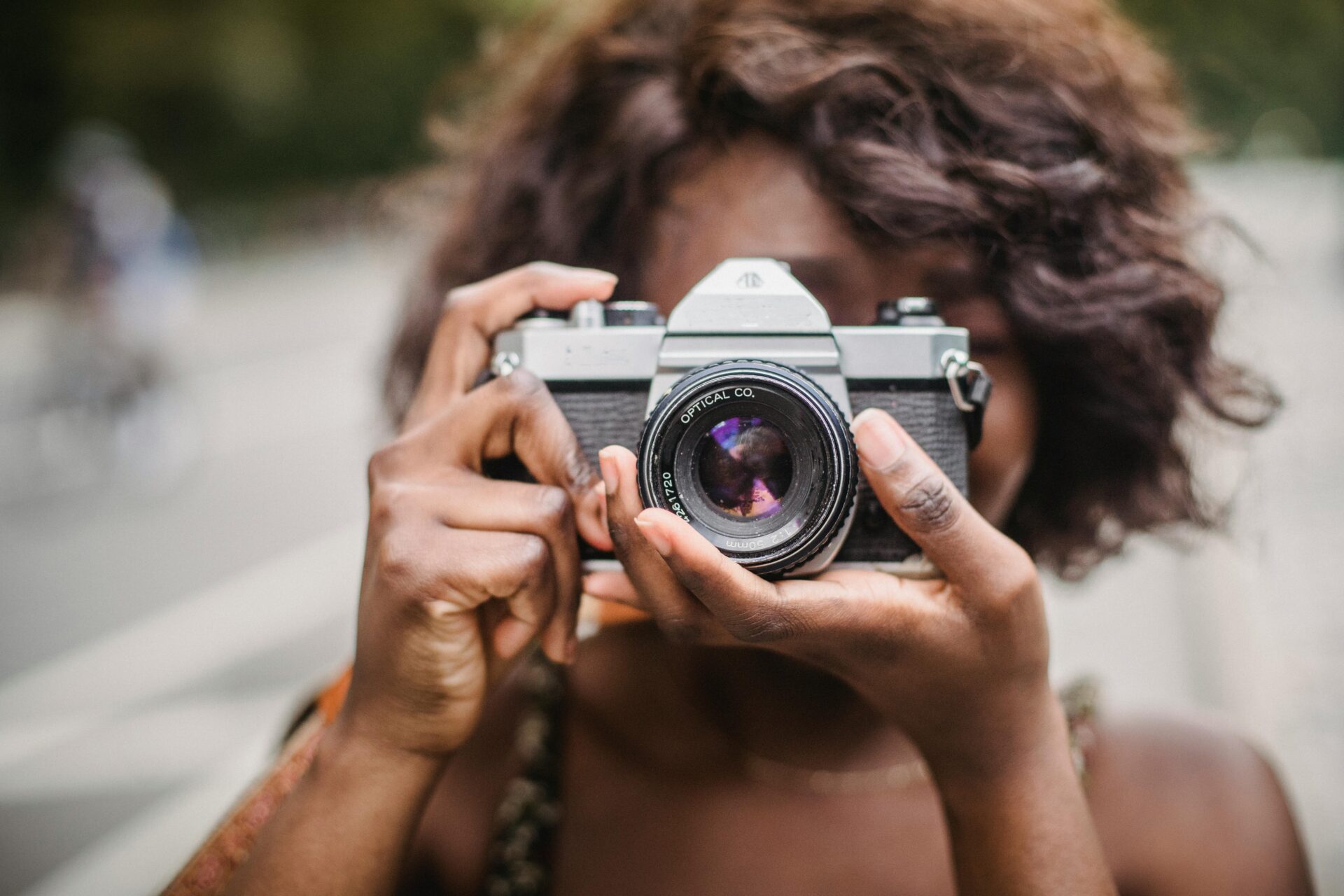 a woman holds a camera taking a picture