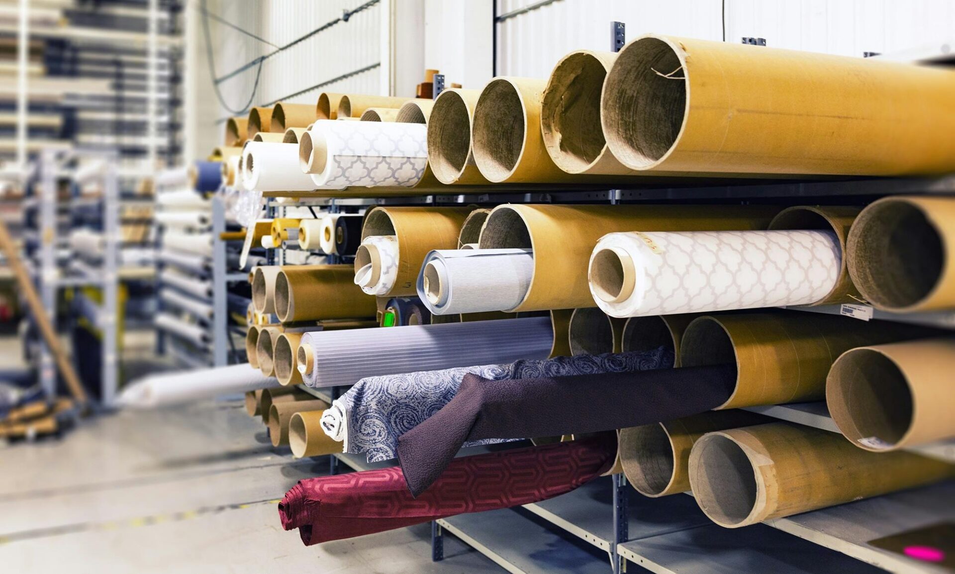 rolls of fabric on a shelf